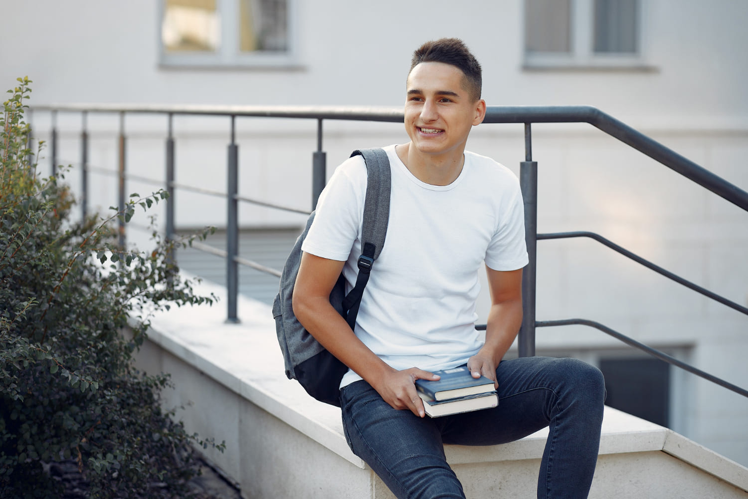 Expat student studying with books on university campus